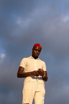 Black man texting on his smartphone