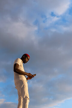 Black man texting on his smartphone