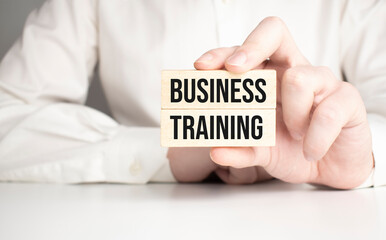 BUSINESS TRAINING text on white paper on gray background. Business concept.