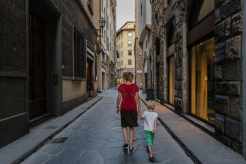 Mother and son on a street in Florence