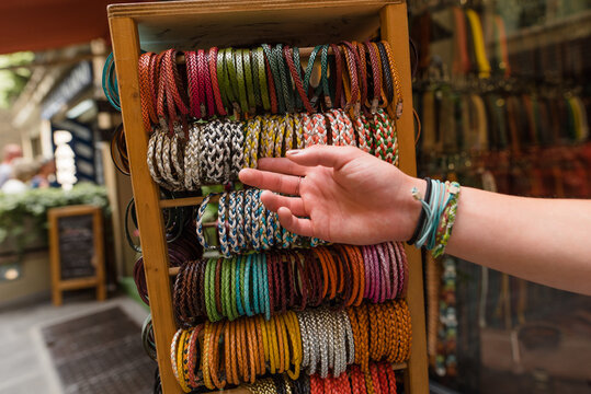 Hand of a teen selecting bracelets