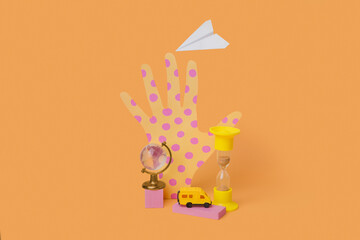Hand, glass globe sand watches, car and paper airplane