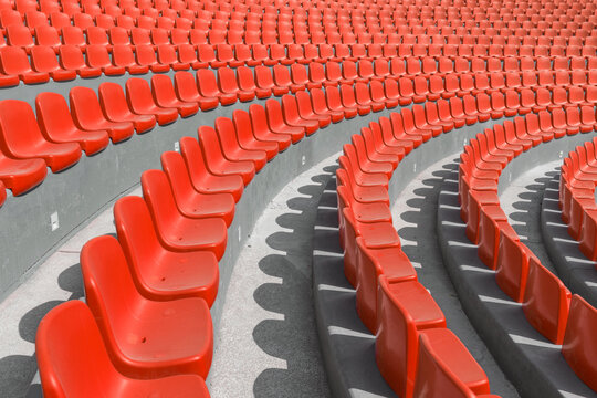 A row of red chairs in a curve