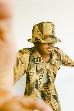 Guy posing in handmade clothing.