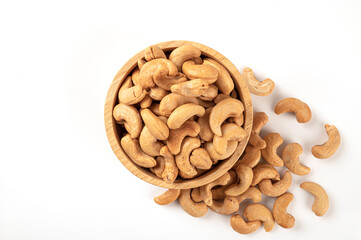 Cashew nut in wooden bowl isolated on white background.