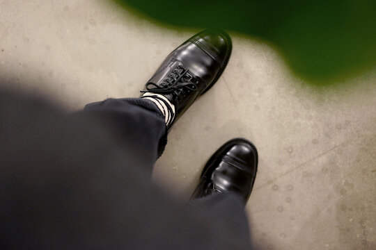 Fototapeta Closeup of vintage leather shoes on feet