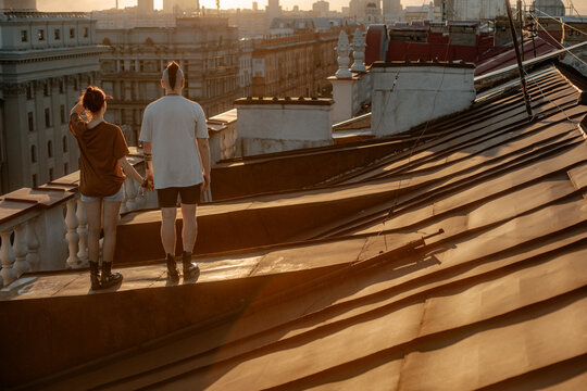 Couple in love on the roof at sunset