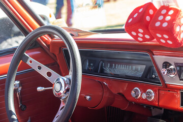 the red interior of an old classic muscle car at a show