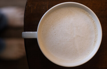 top down view of a foamy latte in the morning after waking up
