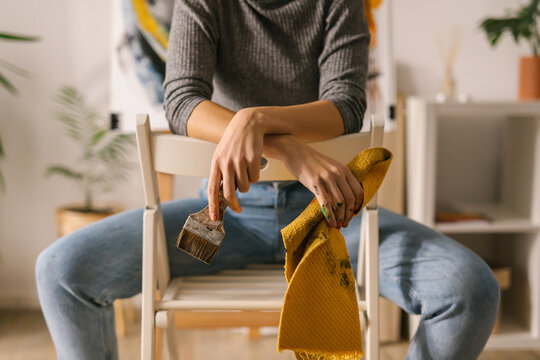 Unknown artist hands holding paint brush and cloth