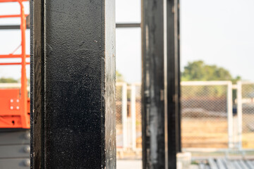 Heavy metal pillar structure of the warehouse building. Industrial construction site and equipment object photo.