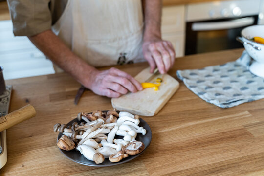 Senior man cooking preparing healhty meal in kitchen