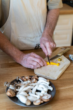 Senior man cooking preparing healhty meal in kitchen