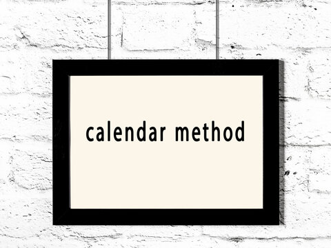 Black frame hanging on white brick wall with inscription calendar method
