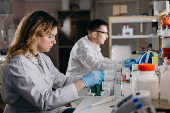 Female researcher in medical uniform working in lab