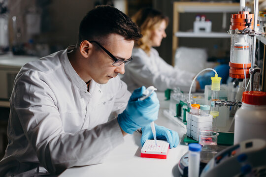 Scientist examining molecular samples in lab