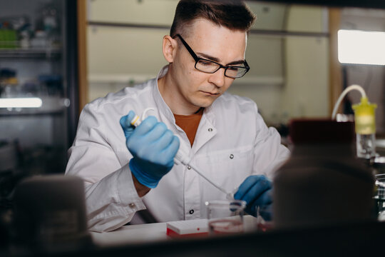 researcher with pipette working in DNA laboratory