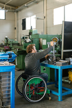 Disabled Man Working In His Workshop