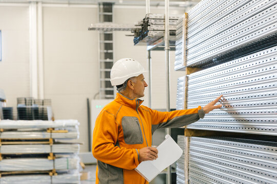 Man Checking Production Statistics Of Aluminium Profiles