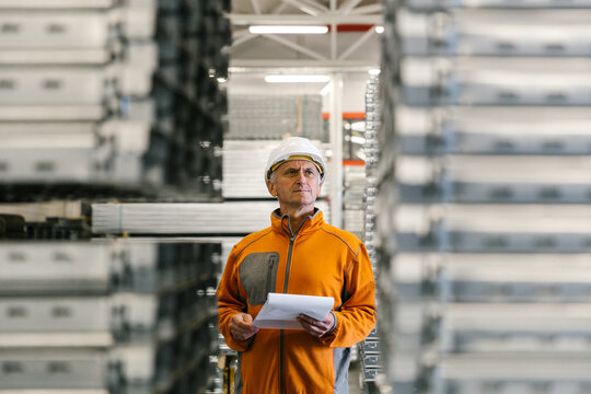 Man Checking Production Statistics Of Aluminium Profiles