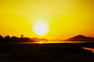 Sunset with yellow sunrays at the coastal area. Sunset in Africa