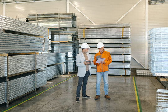 Supervisor In A Factory Inspection With A Worker