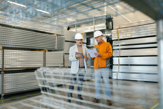 Supervisor In A Factory Inspection With A Worker