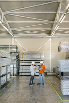 Supervisor In A Factory Inspection With A Worker