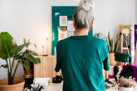 Fashion designer woman from behind in studio