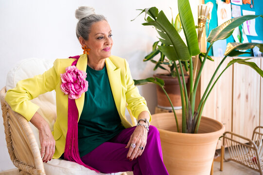 Senior fashion designer woman relaxing in workplace