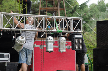people working on the assembly of a stage for live music