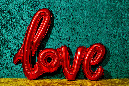 red balloon in the shape of the word love 