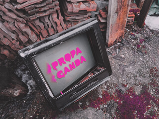 Old TV displaying Propaganda message, text