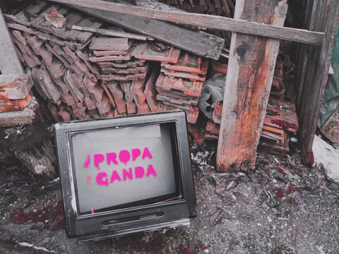 TV on the ground displaying propaganda