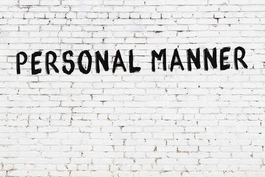 White wall with black paint inscription personal manner on it