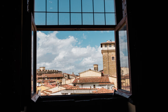 Red tiled roofs in Florence, Italy through an open window