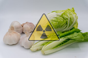 vegetables with radiation warnings.contaminated foods.Radioactive soil.metaphor for nuclear threat.Nuclear leak,Environmental damage.white background.