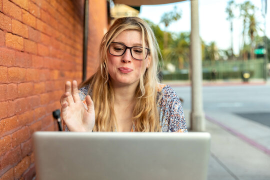 Woman Enjoys Working Outside Cafe