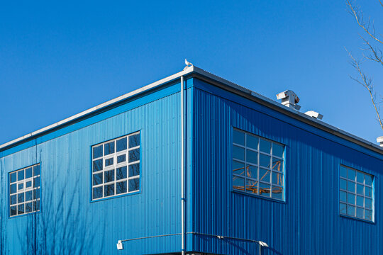The corner of a blue colored aluminum building