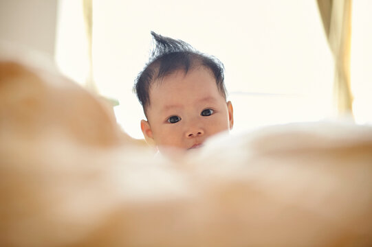 Closeup cute little asian baby in bed