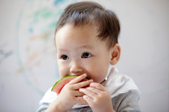 Cute asian baby eating watermelon 