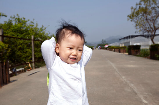 Close Up Asian Kid Running Outdoors

