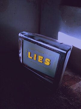 Old TV set showing LIES message