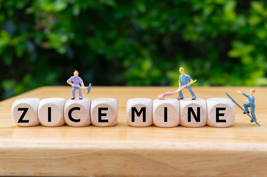 concept of zice mine extraction and international commodity prices. Supplier of minerals for production.written word on dice,miniature workers digging.  Business opportunities to be search