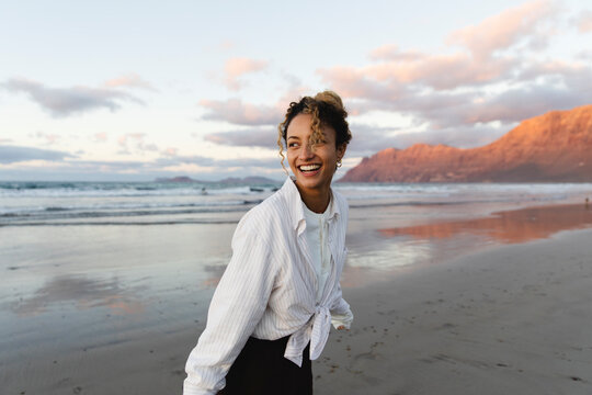 Smiling girl enjoying the beach at sunset