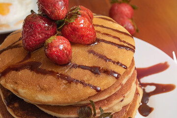 Closeup of hot cakes and strawberries on a table