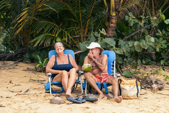 Elderly couple having good time on the beach