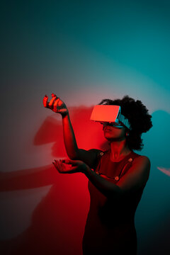 Woman using VR glasses in a virtual playground