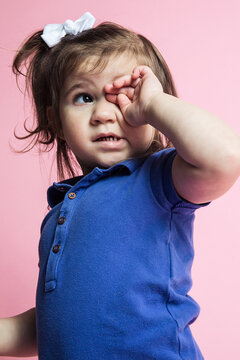 Little girl acting cute in studio