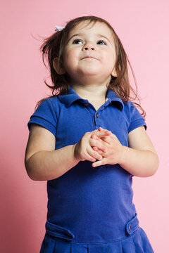 Little girl acting cute in studio